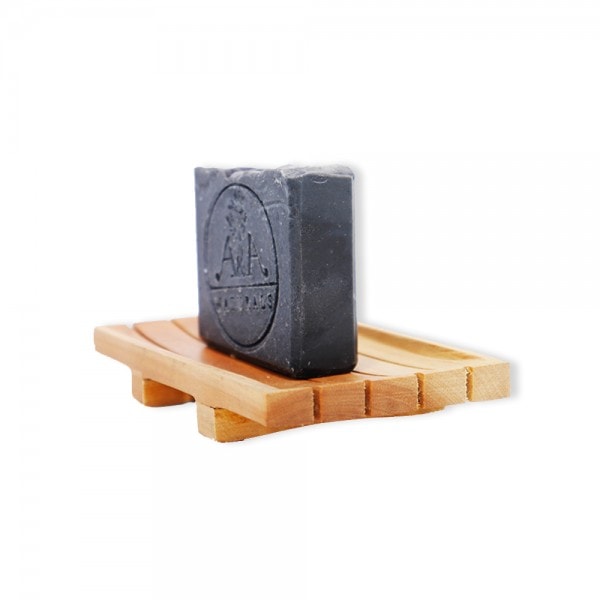 activated charcoal soap on soap dish side view